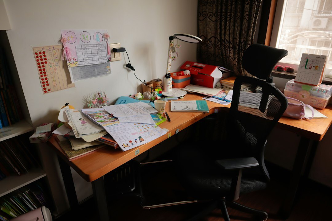 Overhead view of an editorial desk with printed manuscripts, notebooks and a cup of coffee